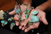 Chester Horse holds his handcrafted jewelry made from turquoise at his home in Hutchinson. Horse is a silversmith and believes that God gave him the gift of creating one-of-a-kind jewelry.