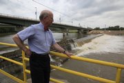 Steven Hill, looks out on the Bowersock Dam that spans the Kansas River, the dam has provided power for Westar and other utilities for years and now is selling green tags to locals and soon Hill hopes to be selling the idea of a new $12 Million dollar hydroelectric plant on the north side.