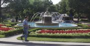 Many people pass the Chi Omega Fountain, where flowers surround the spraying water. Dedicated in 1955, the fountain is central to many university traditions, memories and mischief.