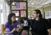 Chris Sakelarios, left, talks with her business partner Eric Geedey last week at Caffe Sportivo in Redwood City, Calif. Sakelarios opened Caffe Sportivo after taking out a $20,000 Small Business Administration loan from Union Bank in late 2007. Within a year, however, she was staying afloat with the help of a landlord and vendors who let her adjust payments.