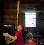 Ottawa Post 60 player Dylan Nelson showcases his bat balancing ability while he and other teammates wait for their turn in the batting cage Tuesday, July 28, 2009. The players practiced Tuesday in an indoor batting facility they call "the cave."