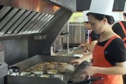 Restaurant staff cook hamburgers Thursday at North Korea’s first fast-food restaurant, the Samtaeseong in Pyongyang, in this video image taken from footage of broadcaster APTN. North Korea’s first fast-food restaurant has become quickly popular among the locals and foreigners in Pyongyang and plans to have branches in the future, a restaurant manager said Thursday.