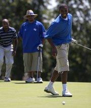 Former KU basketball player Aaron Miles (right) reacts after just missing his putt at the 13th hole. Miles played in Mario Chalmers' tournament on Friday at Alvamar.