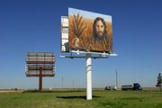 A painting of Jesus in a wheatfield hangs along Interstate 70 last month in Colby. Tuffy and Linda Kay Taylor erected the billboard for Colby residents and motorists who travel down Interstate 70 at all hours of the day and night.