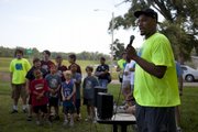 Former Jayhawk basketball player Darnell Jackson speaks to participants of the fifth-annual Red Dog Run shortly before the start of the race Saturday along the Kansas River levee.