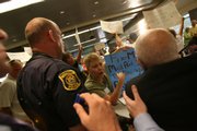 Val Butsicaris, 60, of Taylor, Mich., center, questions Rep. John D. Dingell, D-Mich., at a town hall meeting in Romulus, Mich. Many seniors fear losing benefits under health care reform.