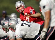 New England quarterback Tom Brady gestures on the line during training camp at the team’s facility on Monday in Foxborough, Mass. Brady said he’s ready for action in the Patriots’ first preseason game on Thursday in Philadelphia. Coach Bill Belichick wouldn’t say how much Brady would play in his first action since suffering a season-ending knee injury last year.