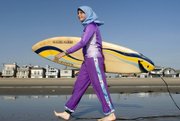 Sama Wareh walks along the sand dressed in swimwear designed for Muslim women Newport Beach, Calif., in this Feb.15, 2007, file photo. A French Muslim was denied entry to a swimming pool for wearing an Islamic-style full-body swimsuit.