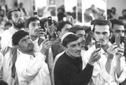 Afghan men use mobile phone cameras to take pictures of presidential candidate and former Finance Minister Ashraf Ghani Ahmadzai during an election campaign stop Saturday in Kandahar, Afghanistan. Afghans will head to the polls on Aug. 20 to elect the new president.