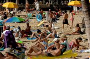 Visitors pack Waikiki Beach in Honolulu in this Feb. 1, 2006, file photo. Hawaii became the 50th state 50 years ago this week, helping transform an island economy dominated by sugar and pineapple fields into a vacation paradise for Americans.