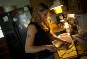 Sarah Skaggs slices celery as she prepares tuna salad, which she refers to as “the official food of the unemployed.”