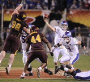 Kansas quarterback Todd Reesing heaves a pass over the Minnesota line as Jake Sharp (1) looks to make a block during the fourth quarter of the Insight Bowl in this photo from Dec. 31, 2008, at Sun Devil Stadium in Tempe, Ariz. Reesing and Sharp both return this season.
