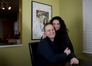 Kellee and Gary Pratt, Lawrence, pose in front of a movie premier poster they had for guests to sign at their movie-themed wedding at Liberty Hall. The couple chose a movie-themed wedding because of their shared love of the cinema.