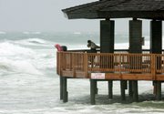 A pavilion that is normally on the beach is surrounded by water Monday as the effects of Tropical Storm Claudette are felt Monday in Destin, Fla.