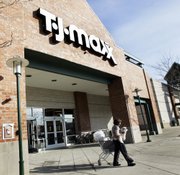 A shopper leaves a T.J. Maxx store Feb. 21, 2007, in Framingham, Mass. Discount retail operator TJX Cos. on Tuesday said its fiscal second-quarter profit rose 31 percent as its stores like T.J. Maxx and Marshalls continued to lure in cost-conscious shoppers.