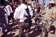 Gun-toting protesters, like this one, right, in Phoenix, have — along with other Nazi imagery, heckling and violent outbursts — contributed to a public atmosphere of anger across the country.