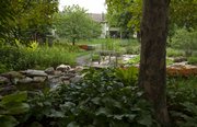The Brandon Woods garden offers a different perspective from any point of view. Above, a small pond is recirculated under a walking bridge.