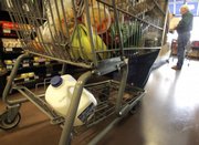 A cart full of a groceries is seen March 24 at the check-out counter at a Kroger store in Gahanna, Ohio. Shoppers are increasingly ditching their items before they’re rung up, as they think twice about spending and obsess about saving amid worries about job security and financial woes.