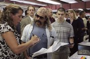 Steve Costa, second from left, interviews at GT Solar during a job fair Thursday at New Hampshire Motor Speedway, host to NASCAR races in Loudon, N.H.