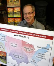 Peter Geiger, editor at the Farmers’ Almanac, holds up a poster predicting an especially cold winter.