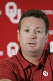 Oklahoma coach Bob Stoops answers a question at a news conference Tuesday in Norman, Okla. The Sooners will open the season Saturday against BYU in Arlington, Texas.