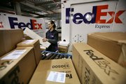 Rosa Santiago sorts packages before loading them onto delivery trucks Dec. 15, 2008, at the FedEx Express Station in New York. At package delivery behemoths FedEx and UPS, Wall Street’s meltdown meant a sharp drop-off in the number of documents and packages sent overnight.