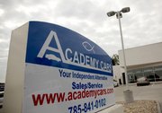 The blackburns have a large ichthys, also known as a “Jesus fish,” on their Academy Cars signage at the company’s new building, 1527 W. Sixth St.