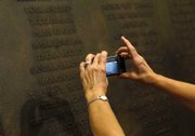 A woman takes a photo of a plaque that honors the victims of Flight 93 that was unveiled Wednesday at the U.S. Capitol in Washington.