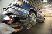 Tony Balster, of Victory Auto Wreckers, loads a car from the Cash for Clunkers program in this Aug. 4 file photo at NorthSide Toyota in Chicago. The popular Cash for Clunkers program this summer showed that budget-conscious Americans will embrace small cars.