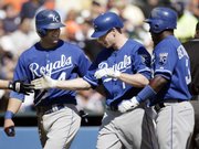Kansas City’s Josh Anderson, center, celebrates with Alex Gordon, left, and Yuniesky Betancourt after hitting a three-run home run. The Royals defeated the Tigers, 9-2, on Thursday in Detroit.