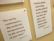Quotes from Dave Ramsey are displayed along with Bible verses in the lobby of Ramsey’s Lampo Group headquarters in Brentwood, Tenn.