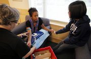 Registered nurse Sara Hoffman, left, draws a blood sample from Ariel Snowden-Wright, of Chicago, as fellow student Cherry Tran comforts her Sept. 10 at Duke University in Durham, N.C. The students are participating in a swine flu genome testing study at Duke funded by the Defense Department.