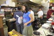 Sisi Srisutiva, 15, helps keep things running by watching the to-go orders, keeping them in order as family members work up more meals.