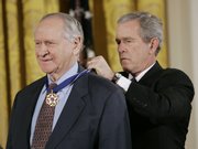 President George W. Bush, right, bestows the Presidential Medal of Freedom to journalist William Safire during a ceremony in the East Room of the White House in this Dec. 15, 2006, file photo. Safire, a Pulitzer Prize-winning conservative columnist, language expert and former White House speechwriter, died Sunday at age 79.