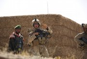 During a lull in a firefight with taliban militants, Afghan Army local commander Mohammed Hussein, left, stands with Marine squad leader Sgt. Matthew Duquette, of Warrenville, Ill., who shouts out orders to Marines from 3rd Platoon, Bravo Company, 1st Battalion 5th Marines, on Sunday in Nawa district, Helmand province, southern Afghanistan.