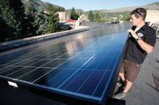 John Shaw, owner of Shaw Solar and Energy Conservation, pauses Aug. 27 next to a portion of a 44-kw grid-tied photovoltaic solar system installed by his company two years prior on the roof of the Smiley Community Building in downtown Durango, Colo.