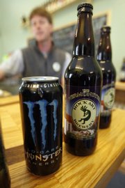 Matt Nadeau displays a can of Monster energy drink and a bottle of Vermonster beer at his Rock Art Brewery in Morrisville, Vt. Nadeau has been told by Hansen Beverage Co., the maker of Monster energy drinks, to stop selling the brew.