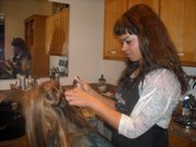 Christina Frazier, right, adds extensions to a client’s hair at her salon, Connections for Hair, in Overland Park. Frazier, a Lawrence resident, travels to Dallas each month to add hair extensions to clients with the Dallas Cowboys cheerleaders.