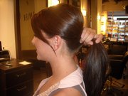 Dallas Cowboys cheerleader Melissa Kellerman shows how much length her hair extensions add. Lawrence resident Christina Frazier now does the hair extensions for the cheerleaders.