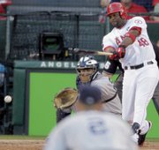 Los Angeles’ Torii Hunter hits a two-run single during Game 5 of the American League championship series. The Angels defeated the New York Yankees, 7-6, on Thursday night in Anaheim, Calif.