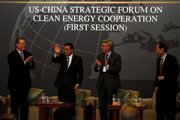 Chinese Vice Premier Li Keqiang, second from left, greets the audience Thursday attending the U.S.-China Strategic Forum on Clean Energy Cooperation in Beijing and is welcomed by former U.S. Vice President Al Gore, left; Chairman of the Board of the Brookings Institute John Thornton, second from right; and an unidentified man at right. Just 57 percent of Americans now think global warming is based on solid evidence.