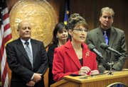 then-Alaska Gov. Sarah Palin addresses members of the media and legislators in Juneau, Alaska, in this Aug. 1, 2008, file photo after the state Senate approved a TransCanada proposal to build a natural gas pipeline.