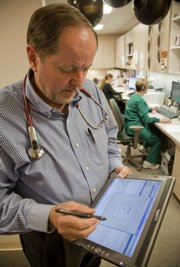 Dr. Steve Bruner of Lawrence Family Medicine & Obstetrics went paperless in 2003 and uses an electronic tablet to record and track patient information. He said the system has saved money and has improved patient care.