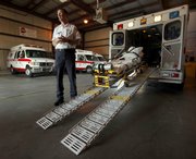 American Medical Response operations manager Ken Keller talks about the specially equipped ambulance used for obese patients at the company’s Topeka facility in this August 2009 file photo. The company charges more to transport obese patients.