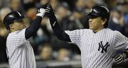 New York Yankees’ Hideki Matsui, right, is congratulated by Jerry Hairston Jr. after hitting a home run against Philadelphia Phillies pitcher Pedro Martinez during the sixth inning. The Yankees won, 3-1, on Thursday in New York.