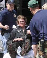 Scott Mason gets ready in this April 28 file photo to go to the hospital in Pinkham Notch, N.H. Mason was fined $25,000 by the state for the cost of his search and rescue.