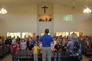 Jeff Ingle, associate pastor at Eudora Baptist Church, leads the congregation in worship Sunday. It was the first worship service in the church’s new building.