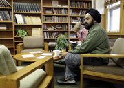 Professor Amardeep Singh sits in a common room at Lehigh University in Bethlehem, Pa., in this photo taken Thursday. Many Indians in America still find it difficult to keep their cultural heritage, as illustrated by a girl who pierced her nose and was suspended from school.