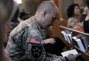 A soldier reads a Bible during Sunday church service at the 1st Air Cavalry Division Memorial Chapel at Fort Hood, Texas.