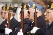 Lyn Faulconer, Lawrence, a member of the Sons of the American Legion, stands at attention following a 21-gun salute in honor of Veteran's Day, Wednesday, Nov. 11, 2009 at the American Legion, 3408 W. 6th Street.